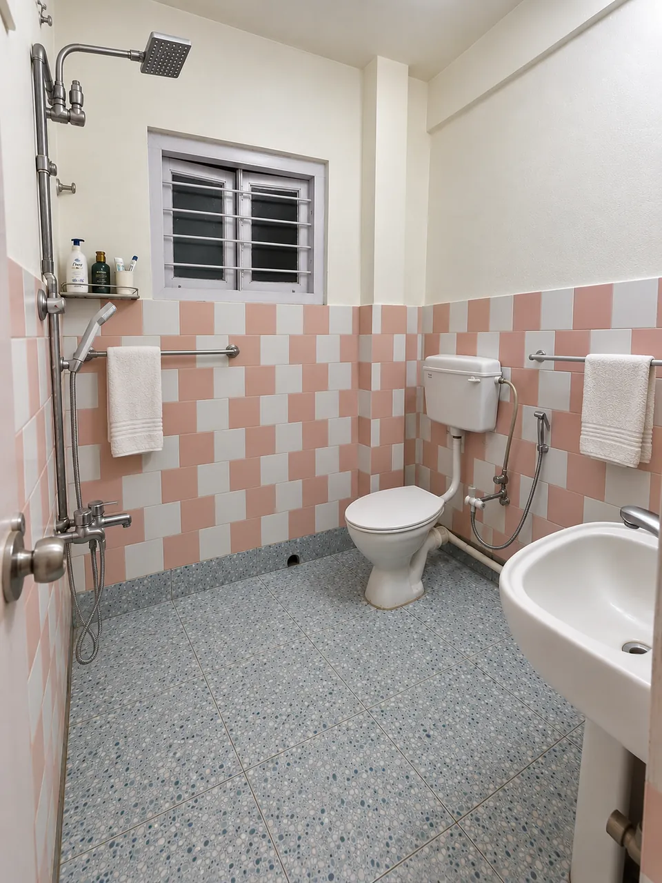 Bathroom with a shower, western toilet, wash basin and fresh towels
