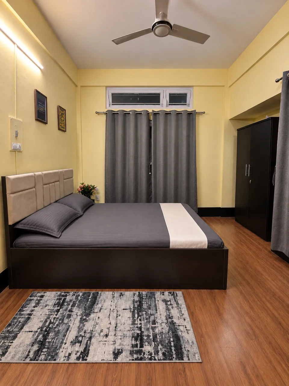 Bedroom 2 from the doorway, showing the queen bed, a rug and the wardrobe