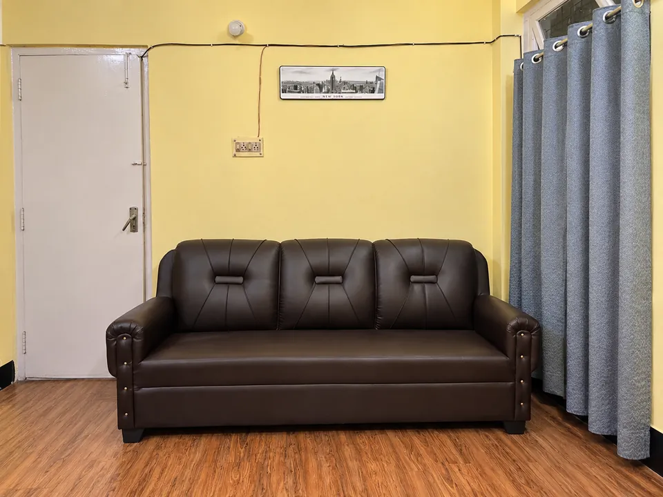 3-seat leather sofa beside the entrance door